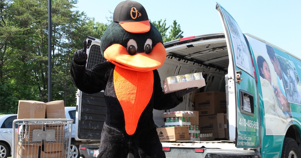 Orioles Bird helping a partner load their van with food