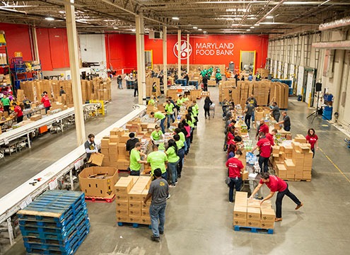 volunteers packing boxes in warehouse