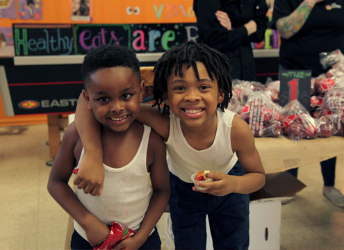 children smiling at HEART Market