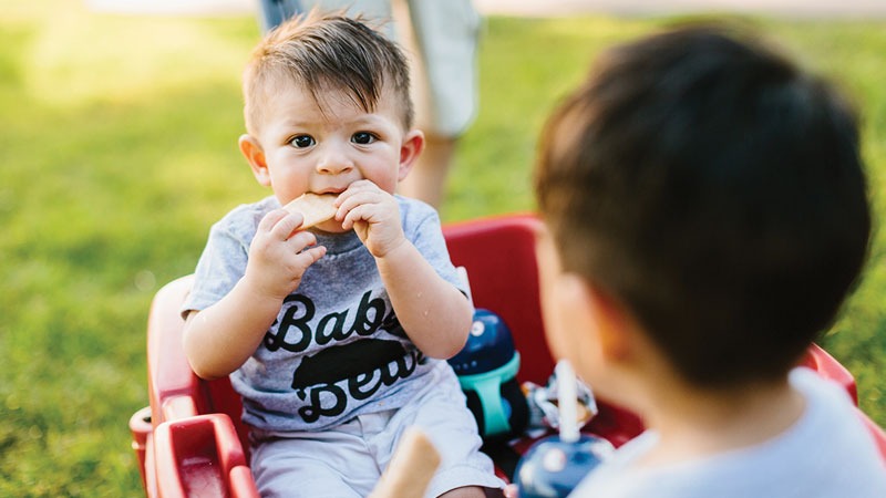 baby toddler eating in wagon
