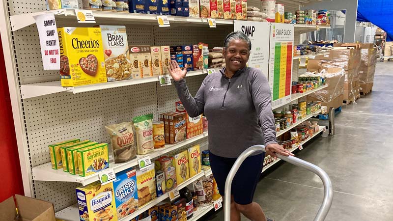 Darlene Johnson standing by Marketplace shelves