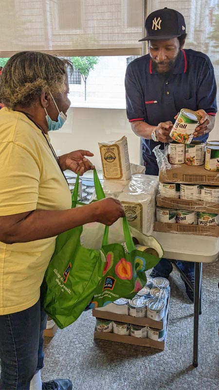 Westminster resident being given canned goods at Pantry On The Go
