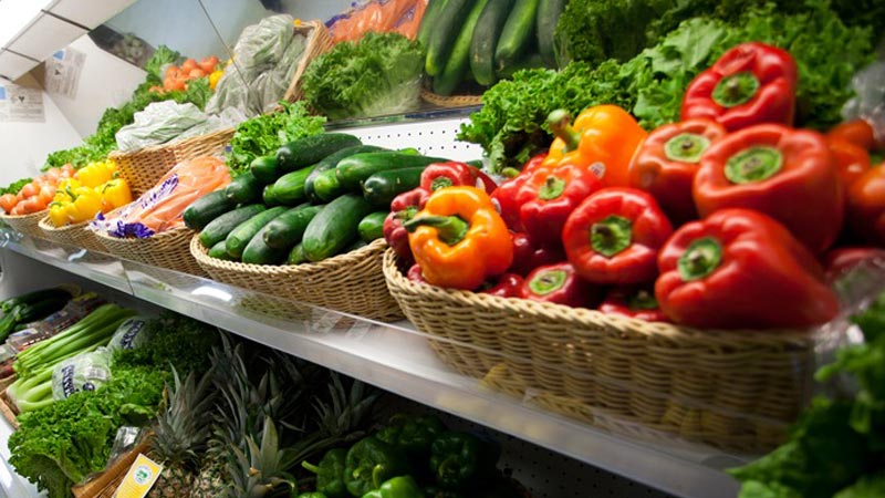 fresh produce on grocery store shelving