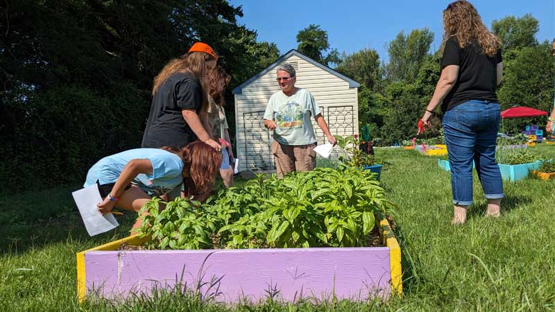 students with teacher in Maryland Food Bank's Education Garden