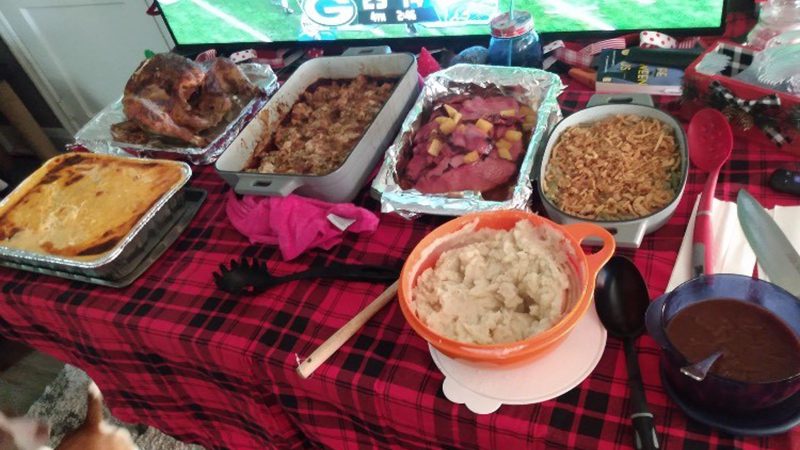 family Thanksgiving table full of homemade foods