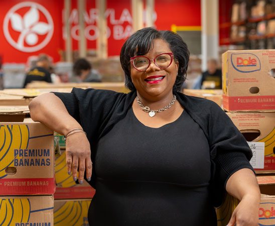 Nakia Coleman leaning on stacked boxes