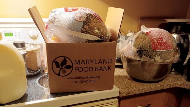 opened Maryland Food Bank Holiday Meal box on the stove with turkeys