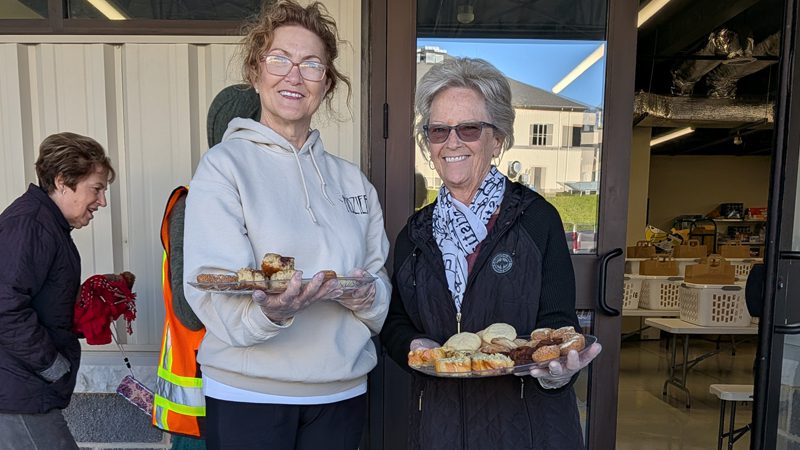 Firanza and her friend hand out fresh baked goods at a Chesapeake Cares food distribution