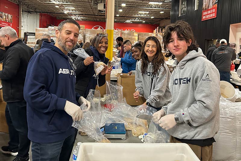 Aerotek volunteers smile around a table at Maryland Food Bank for Martin Luther King, Jr. Day of Service