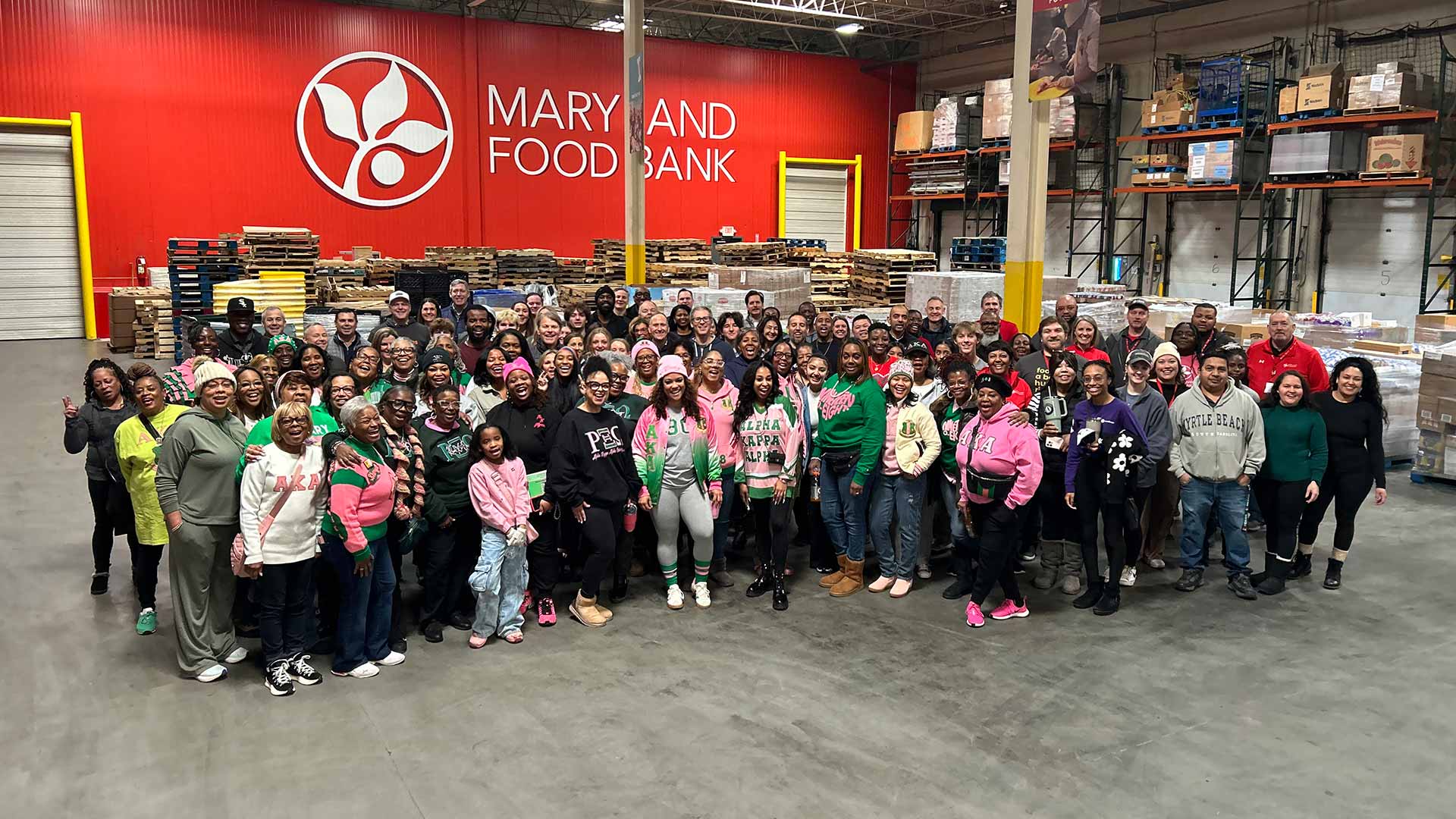 Martin Luther King, Jr. Day of Service Volunteer group posed together in Maryland Food Bank warehouse