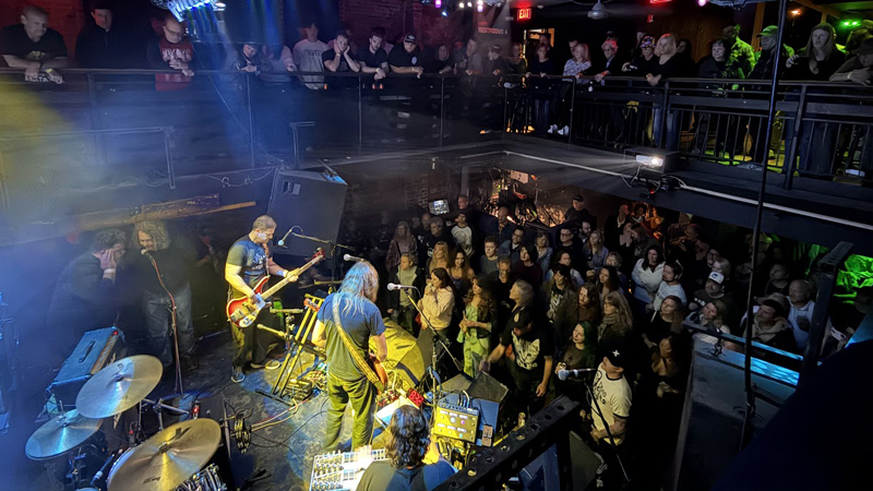 Chris Keith and his band play onstage at the 8x10 for a large crowd